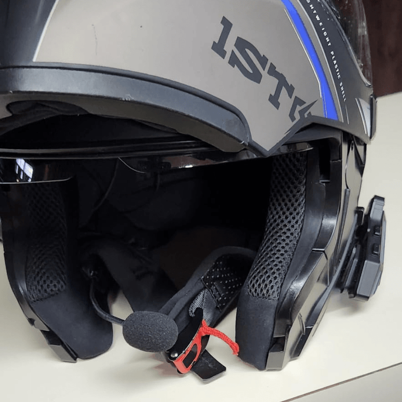 Close-up of the Ride Buddy Bluetooth Headset installed inside a motorcycle helmet, showcasing the microphone and speaker setup