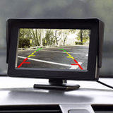 Universal CarPlay Dashboard screen showing rearview camera view with colored parking guidelines.