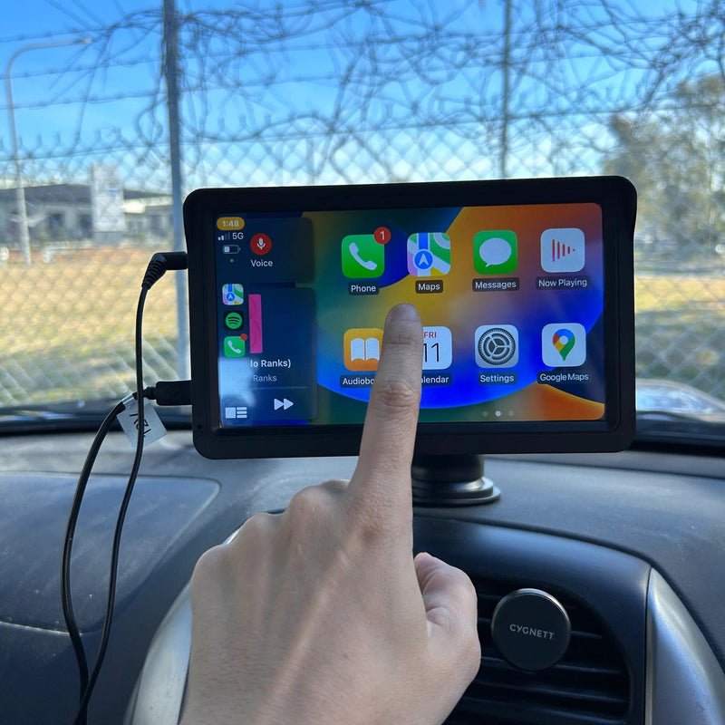 Close-up of a user interacting with the Universal CarPlay Dashboard, accessing apps like Phone, Maps, and Messages on a car touchscreen